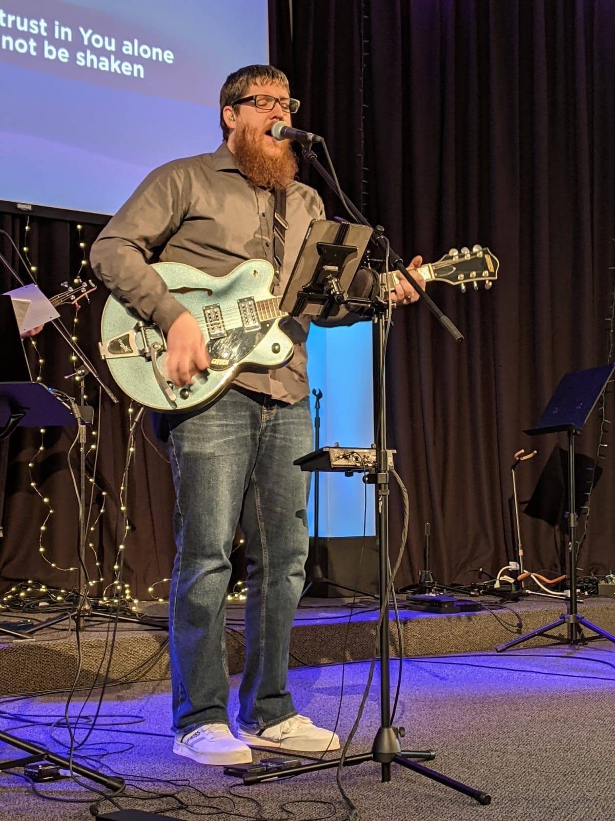 Stefan playing guitar and singing.